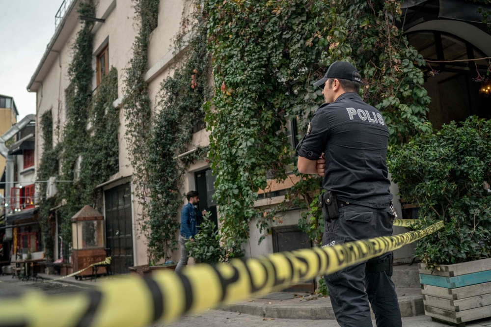A Turkish police officer stands guard outside the Mayday Rescue offices on November 11, 2019, in the Karakoy district of Istanbul, following the discovery of the body of the organisation's founder. AFP / Bulent Kilic 
