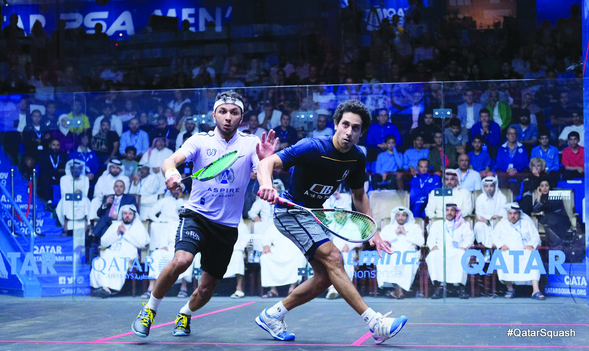 Qatar’s Abdulla Al Tamimi (left) in action against Egyptian No.2 seed Tarek Momen during their PSA World Championship last-16 match at the Khalifa International Tennis and Squash Complex, yesterday.