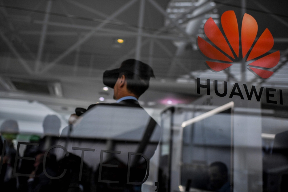 People visit the stand of Chinese telecom giant Huawei during the Web Summit in Lisbon on November 6, 2019. AFP / PATRICIA DE MELO MOREIRA