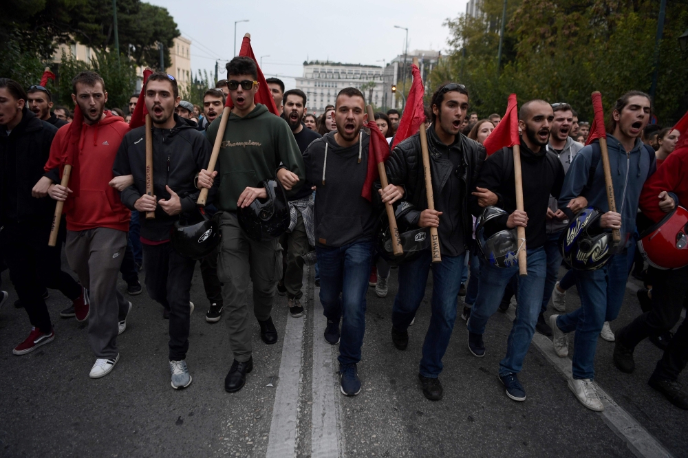 Students shout slogans during the annual march towards the US embassy on November 17, 2019 in Athens, to mark the 1973 students' uprising against the US-backed military junta.  / AFP / ARIS MESSINIS 
