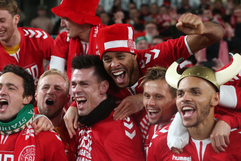 Denmark's players celebrate qualifying for the finals on the pitch after the Group D Euro 2020 football qualification match between Republic of Ireland and Denmark at Aviva Stadium in Dublin, Ireland on November 18, 2019. The game finished 1-1, Denmark qu