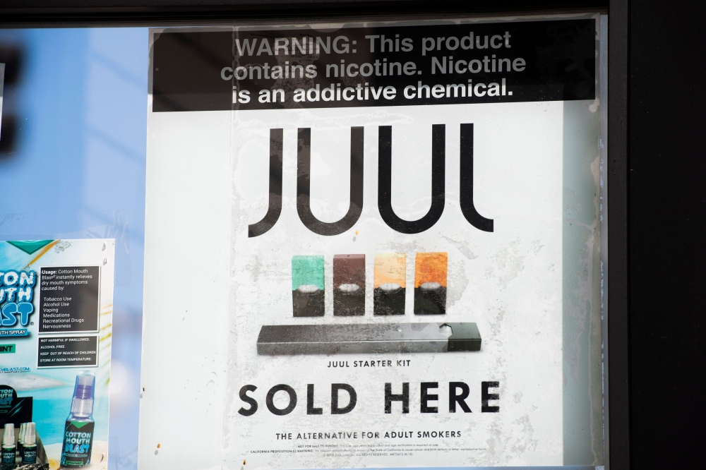In this file photo taken on September 17, 2019 A sign advertises juul vaping products in Los Angeles, California. New York on November 19, 2019 became the second state this week to sue juul, the United States' largest electronic cigarette manufacturer, fo