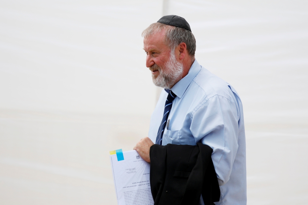 Israeli Attorney-General Avichai Mandelblit holds documents as he attends a weekly cabinet meeting in the Jordan Valley, in the Israeli-occupied West Bank September 15, 2019. Reuters/Amir Cohen