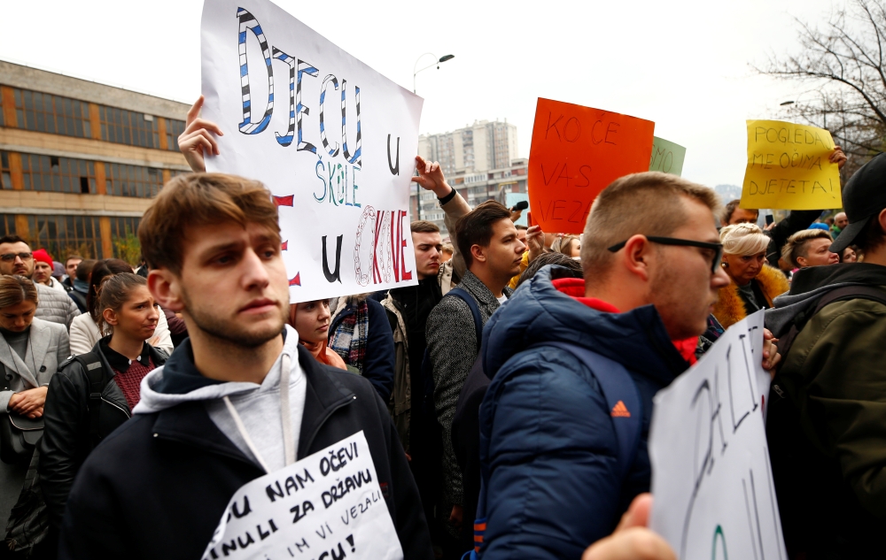 Protesters hold placards during protest against abuse in an institution for children with special needs after photographs emerged of children tied to beds and radiators in Sarajevo, Bosnia and Herzegovina November 21, 2019. Reuters/Dado Ruvic
 