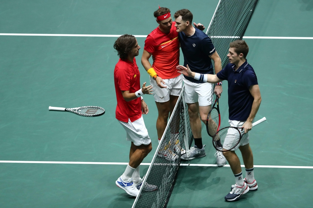 Spain's Rafael Nadal (2L) and Spain's Feliciano Lopez (L) are congratulated by Great Britain's Jamie Murray (2R) and Great Britain's Neal Skupski after winning the semi-final doubles tennis match between Great Britain and Spain at the Davis Cup Madrid Fin