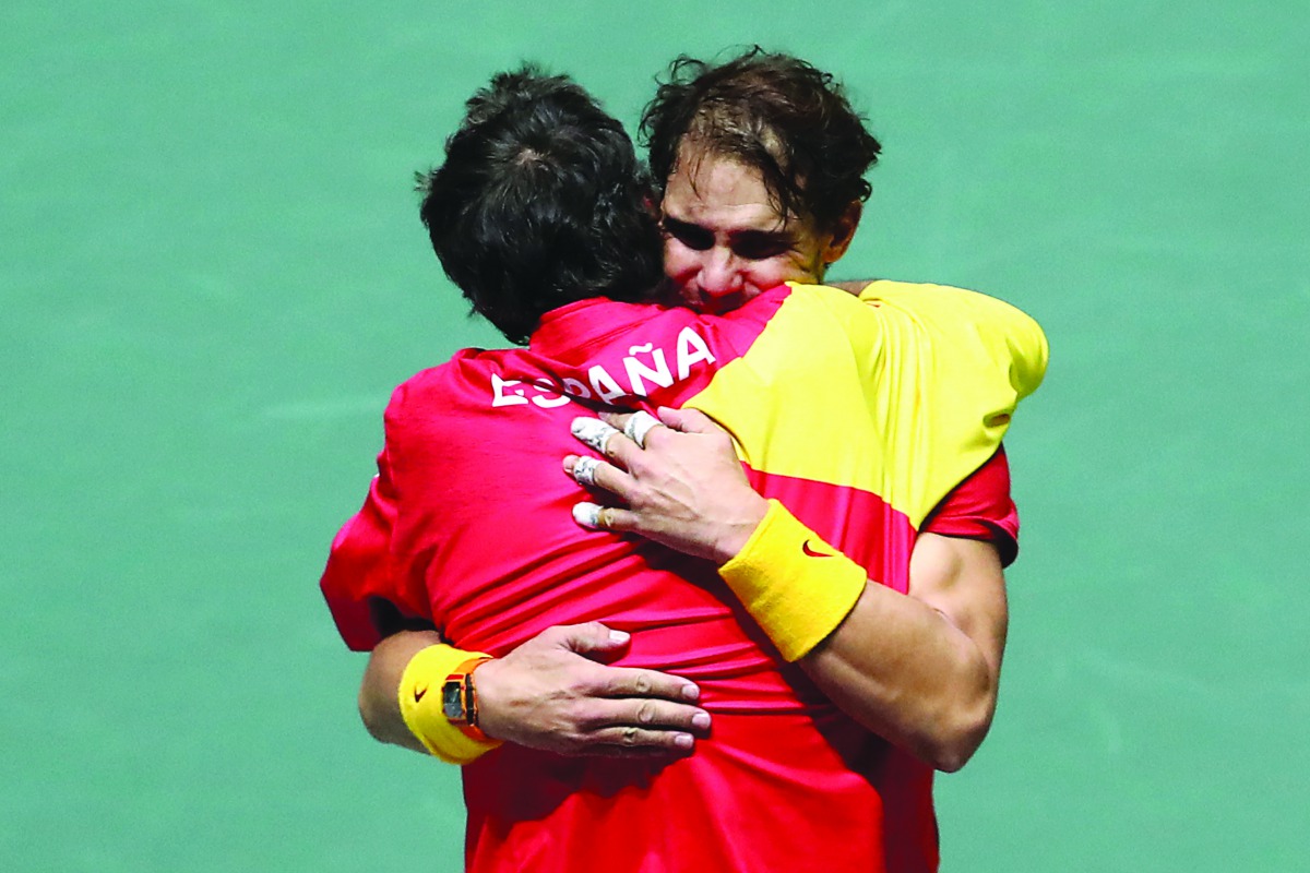 Spain captain Sergi Bruguera celebrates with Rafael Nadal after winning his doubles match with Feliciano Lopez against Britian's Jamie Murray and Neal Skupski. Reuters/Sergio Perez