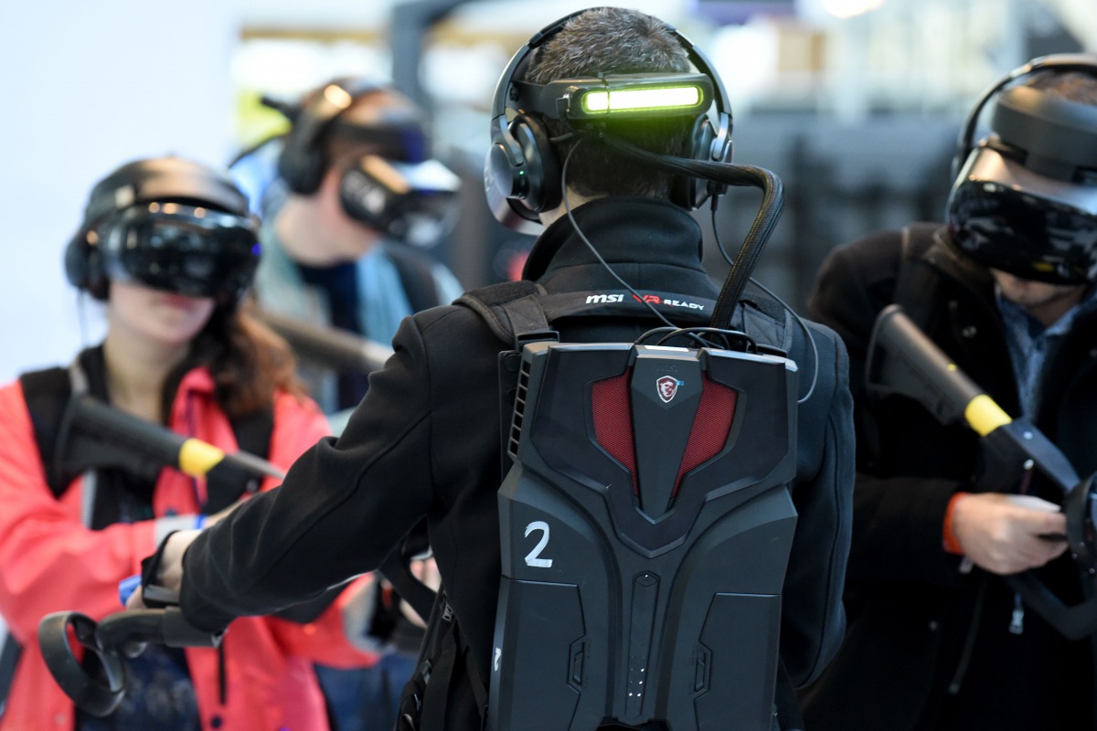 Visitors test devices at the Virtuality Paris 2019 show, dedicated to Virtual technology and immersive technologies, in Paris on November 21, 2019. AFP / Eric Piermont
