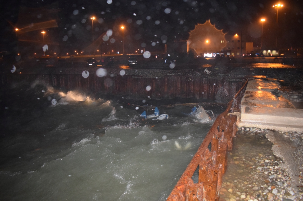 A sailing boat where two people were found dead is seen half submerged in the water after a storm, next to a pier in Antirio, Greece, November 24, 2019. Picture taken November 24, 2019. REUTERS/Vassilis Delimaris