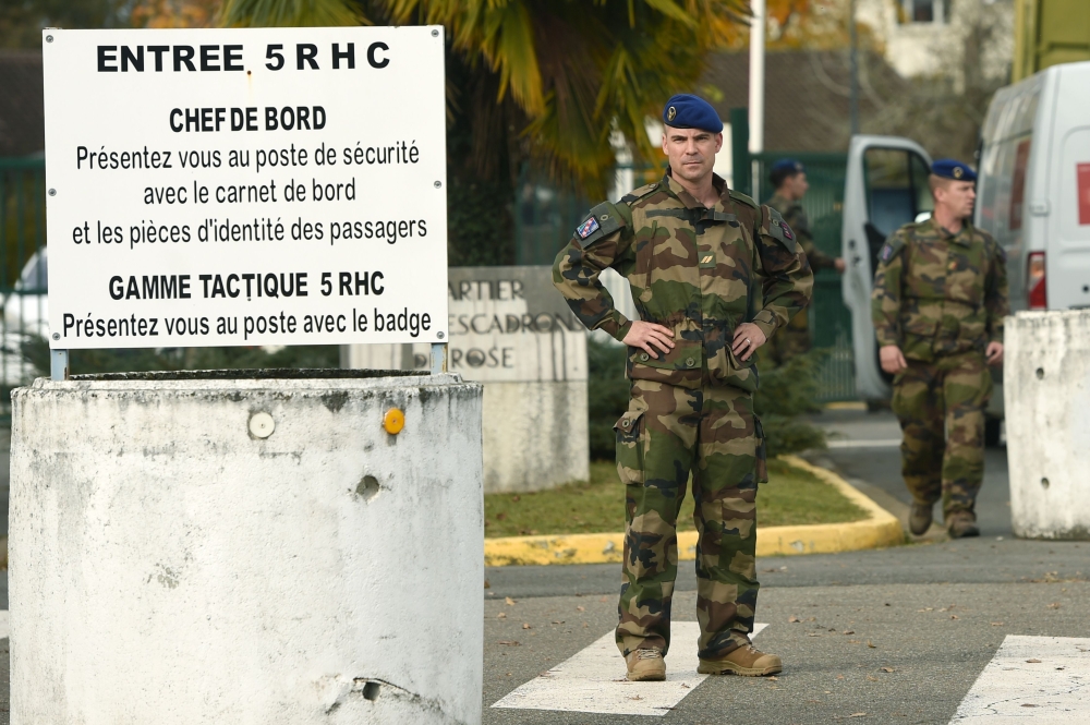 French soldiers stand on November 26 2019 at the entrance to the base of the 5th RHC (Fighter Helicopter Regiment) in Uzein, southwestern France, where were affected seven of the 13 soldiers killed in the helicopter crash in Mali. AFP / GAIZKA IROZ