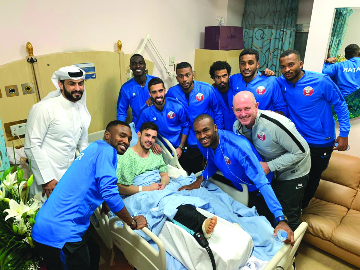 Qatari players and officials with injured Bassam Al Rawi. Picture: Twitter / @alkasschannel