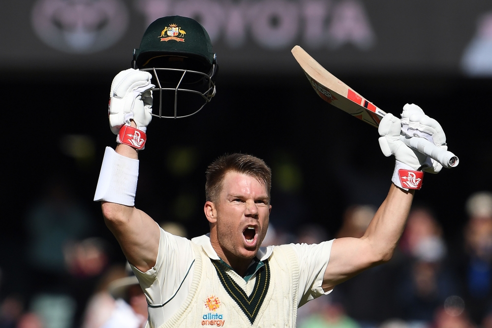 Australia's batsman David Warner celebrates reaching his triple century (300 runs) during day two of the second cricket Test match between Australia and Pakistan in Adelaide on November 30, 2019. AFP / William WEST / 