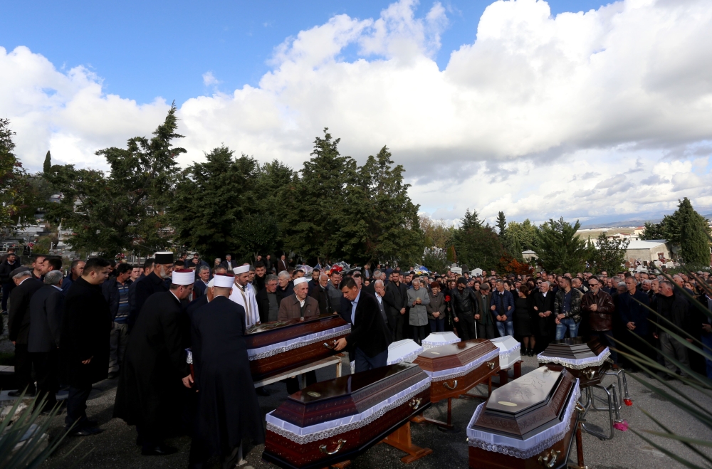 Relatives and family attend the funeral of eight Lala family members who died during the earthquake in Durres, on November 30, 2019. AFP / Gent SHKULLAKU