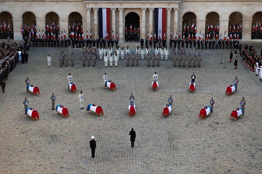 France's President Emmanuel Macron stands in front of coffins of the 13 French soldiers killed in Mali during a tribute ceremony on December 2, 2019 at the Invalides monument, in Paris. AFP /  Eliot Blondet
 