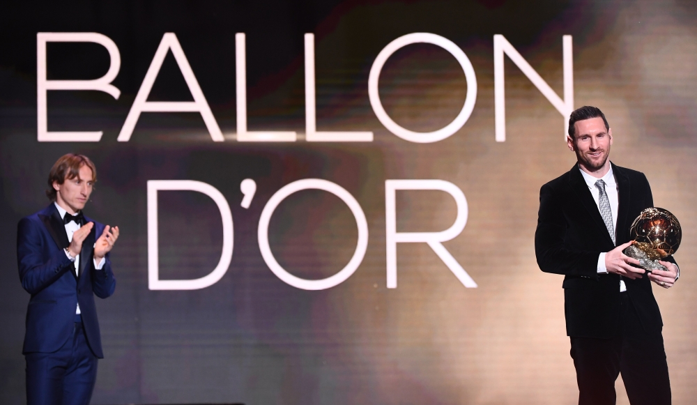 Barcelona's Argentinian forward Lionel Messi reacts after winning the Ballon d'Or France Football 2019 trophy next to Real Madrid's Croatian midfielder and last year's Ballon d'Or winner Luka Modric at the Chatelet Theatre in Paris on December 2, 2019. AF