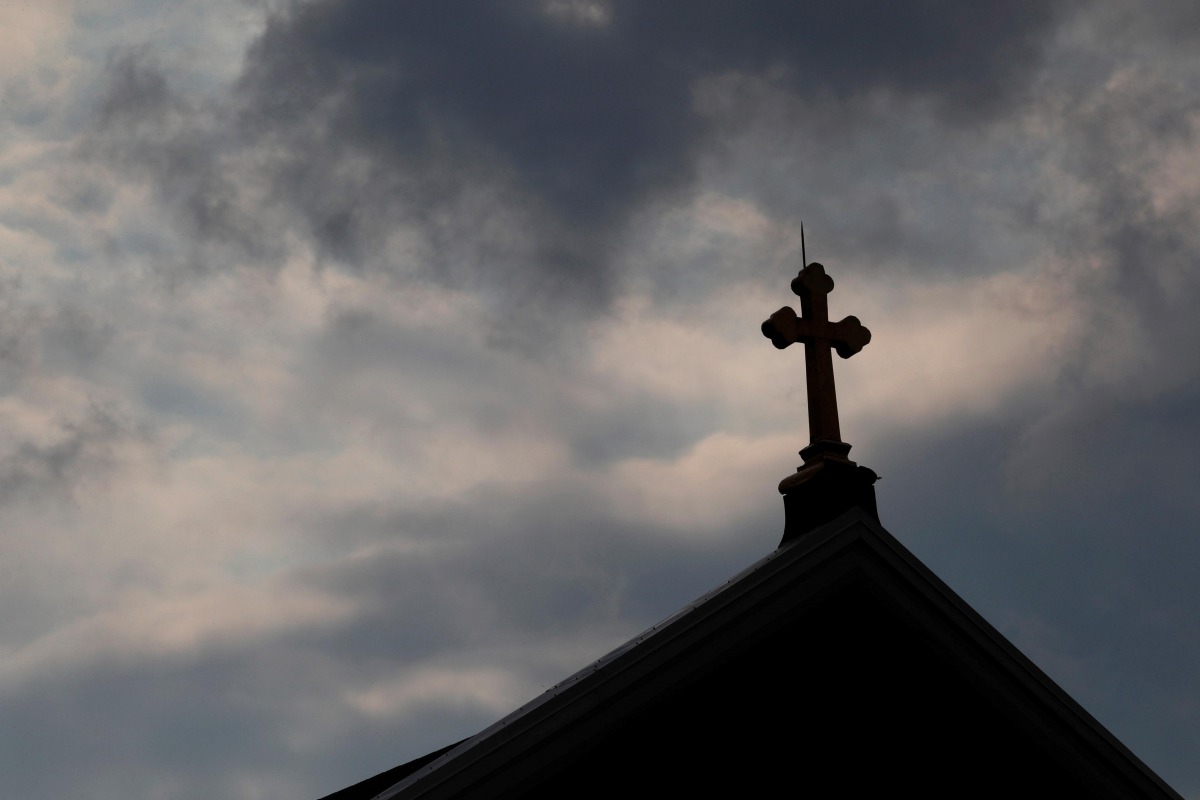 Storm clouds pass over a Roman Catholic church in Pittsburgh, Pennsylvania, US, August 14, 2018. Reuters/Jason Cohn  