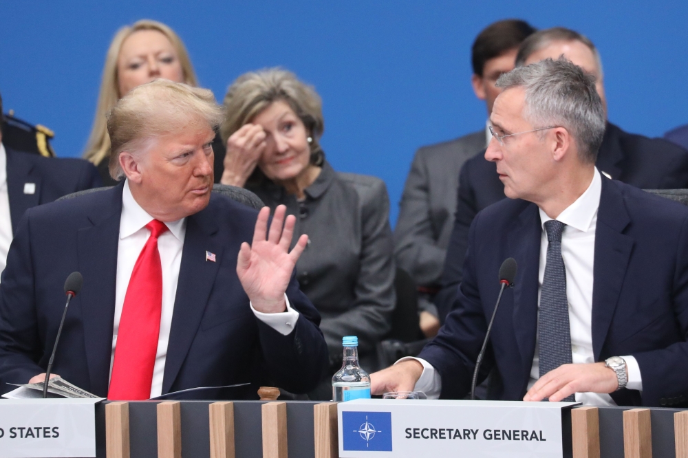 US President Donald Trump (L) speaks with NATO Secretary General Jens Stoltenberg during the plenary session of the NATO summit at the Grove hotel in Watford, northeast of London on December 4, 2019. / AFP / POOL / LUDOVIC MARIN