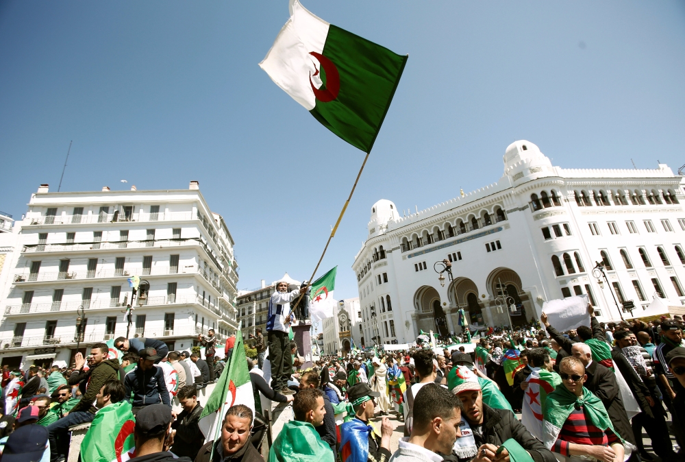 People carry national flags during a protest to demand the removal of of the then president Abdelaziz Bouteflika in Algiers, Algeria, March 29, 2019. Reuters / Ramzi Boudina