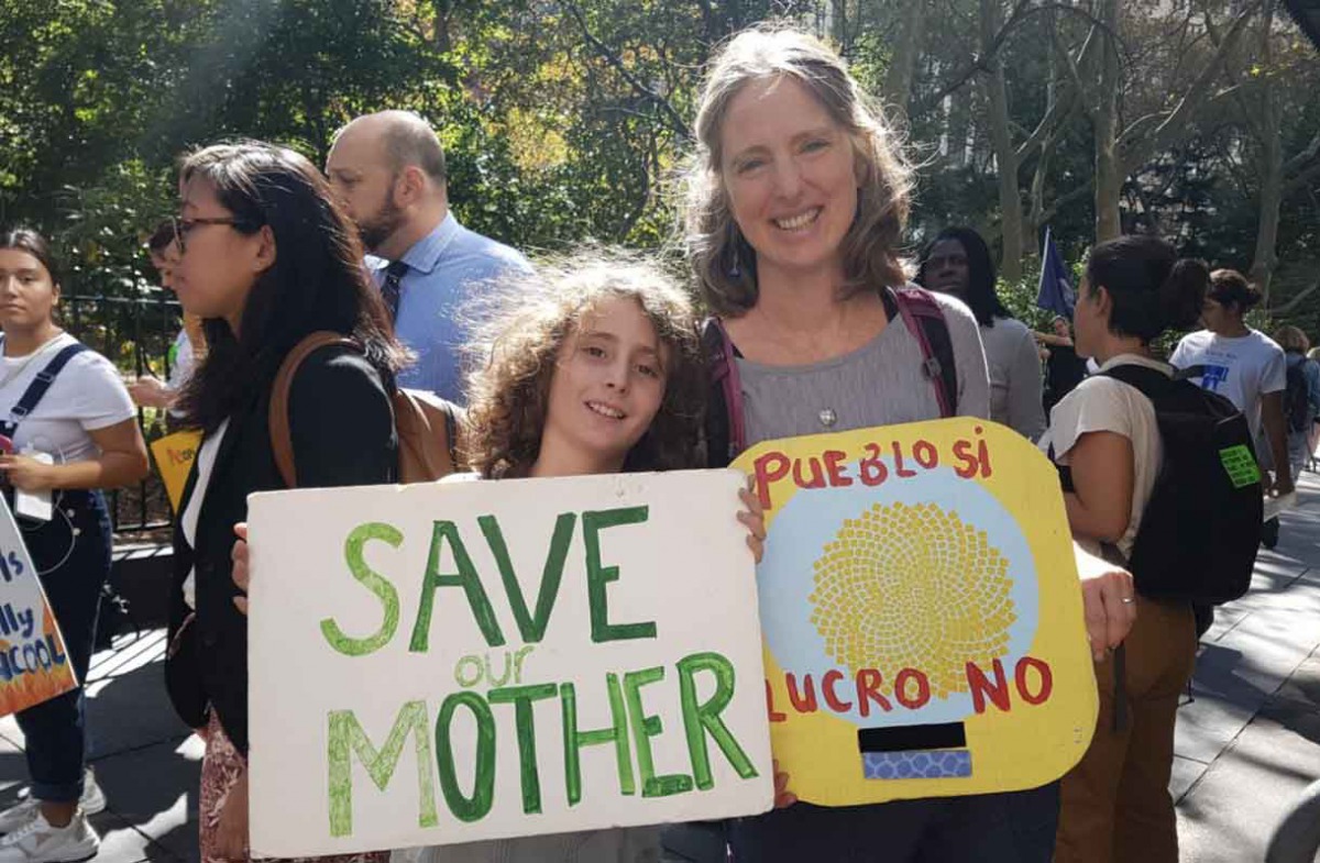 Aaron Thomases, 9, and his mother Teresa Elguera at the climate strike outside City Hall in New York City on September 27, 2019. Thomson Reuters Foundation / Rachel Savage