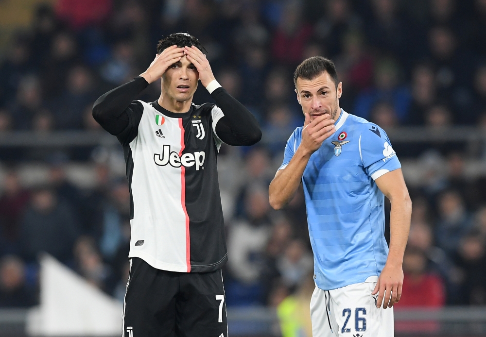 Juventus' Cristiano Ronaldo and Lazio's Stefan Radu react REUTERS/Alberto Lingria
