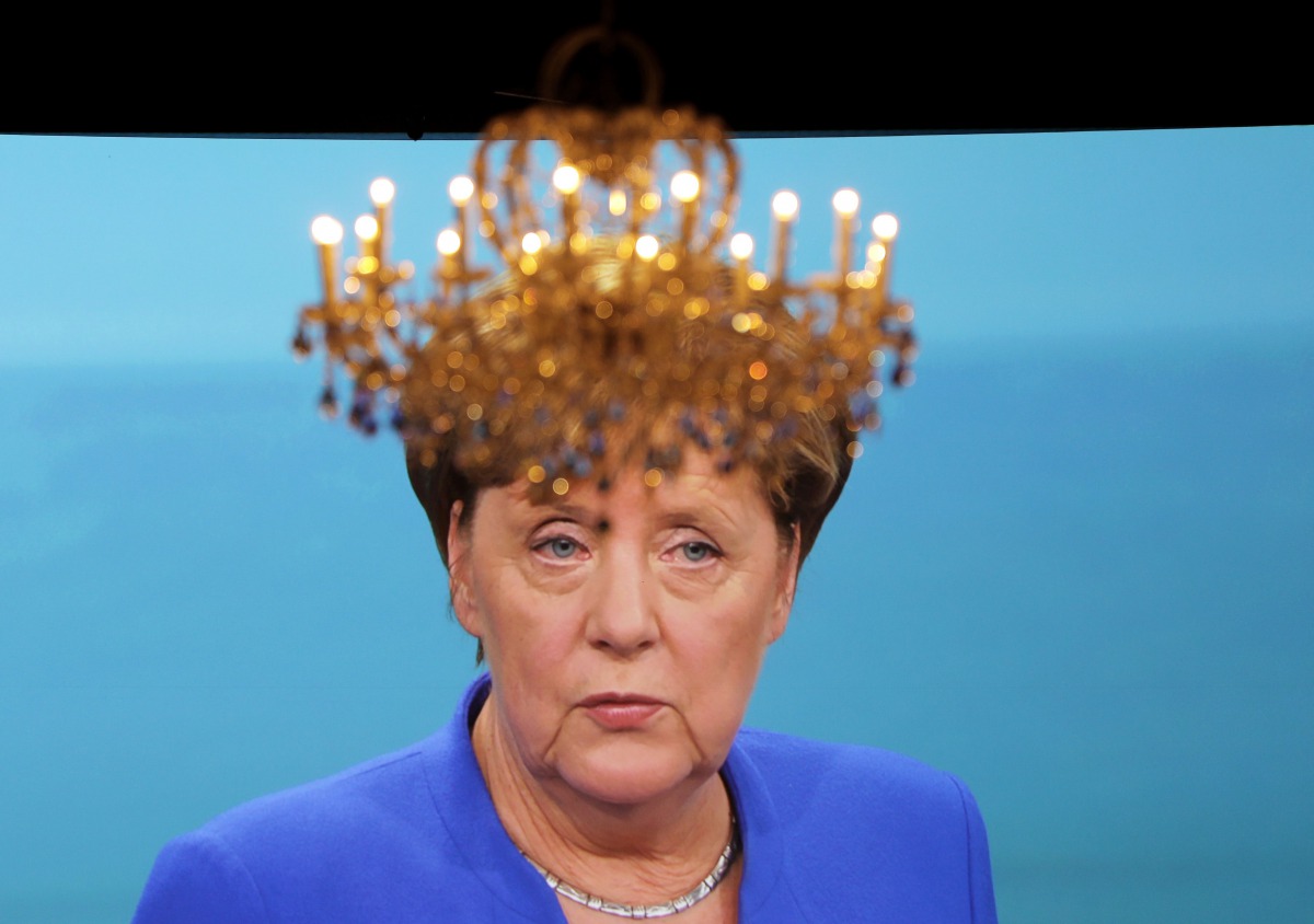 A chandelier hangs in front of a giant TV screen showing German Chancellor Angela Merkel on September 03, 2017. AFP / dpa / Kay Nietfeld