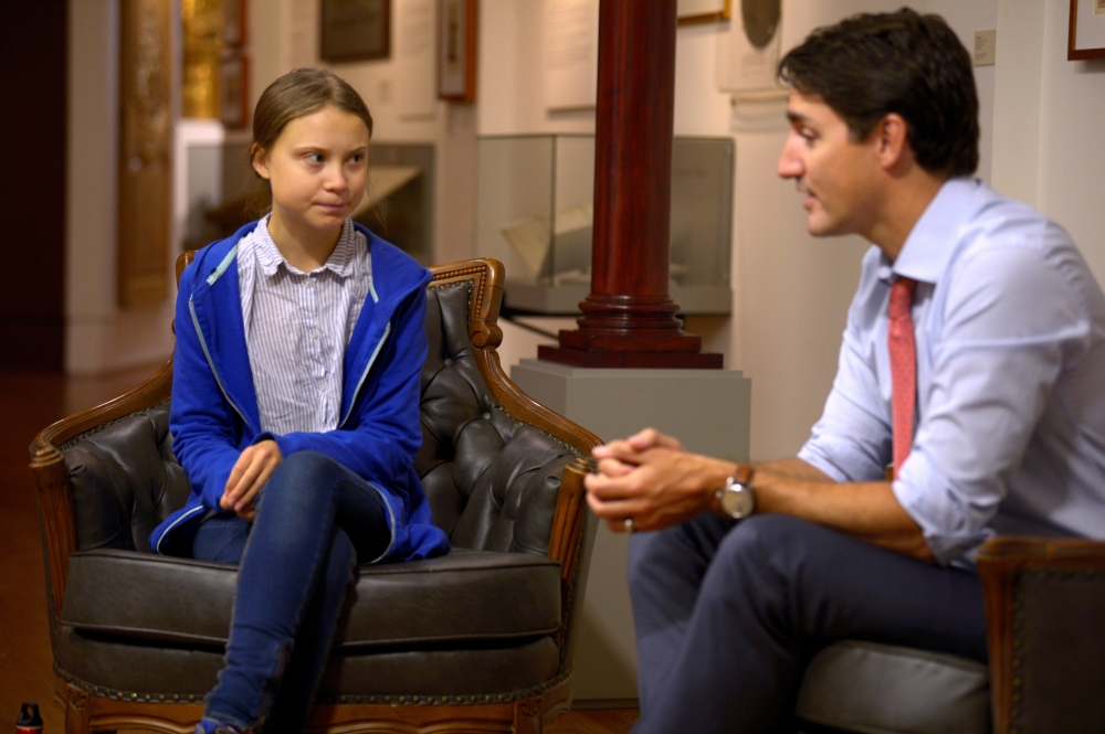 FILE PHOTO: Prime Minister Justin Trudeau greets Swedish climate change teen activist Greta Thunberg before a climate strike march in Montreal, Quebec, Canada, September 27, 2019. Reuters /  Andrej Ivanov