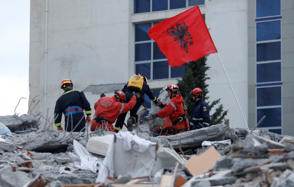 Emergency personnel put an Albanian flag on top of rubble on the occasion of the Albanian Independence Day during a search for earthquake survivors, November 28, 2019. Reuters / Florion Goga