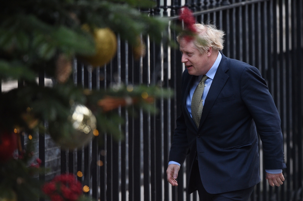Boris Johnson arrives at 10 Downing Street in central London on December 13, 2019, following an audience with Britain's Queen Elizabeth II at Buckingham Palace, where she invited him to become Prime Minister and form a new government.  AFP / Oli Scarff
 