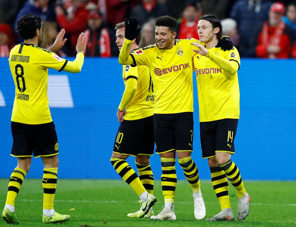 Borussia Dortmund's Nico Schulz celebrates scoring their fourth goal with teammates REUTERS/Ralph Orlowski 