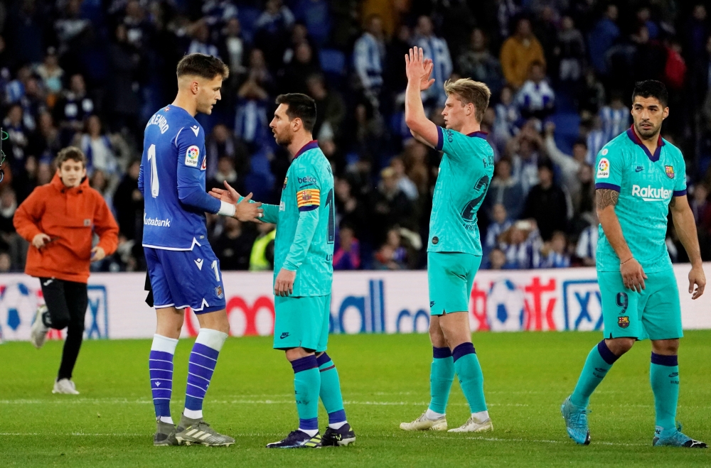 Alex Remiro shakes hands Lionel Messi after the match . San Sebastian, Spain . December 14, 2019 . REUTERS/Vincent West
