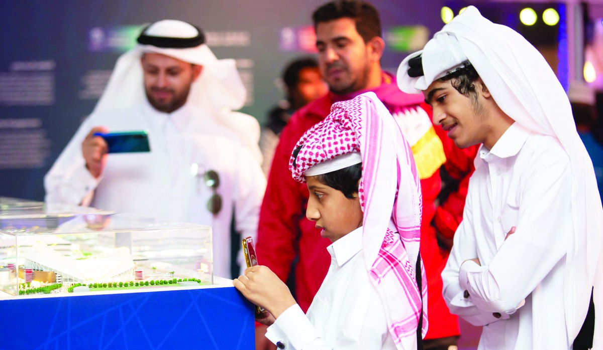Visitors look at the FIFA World Cup Qatar 2022 stadium’s model at Darb Al Saai. 
