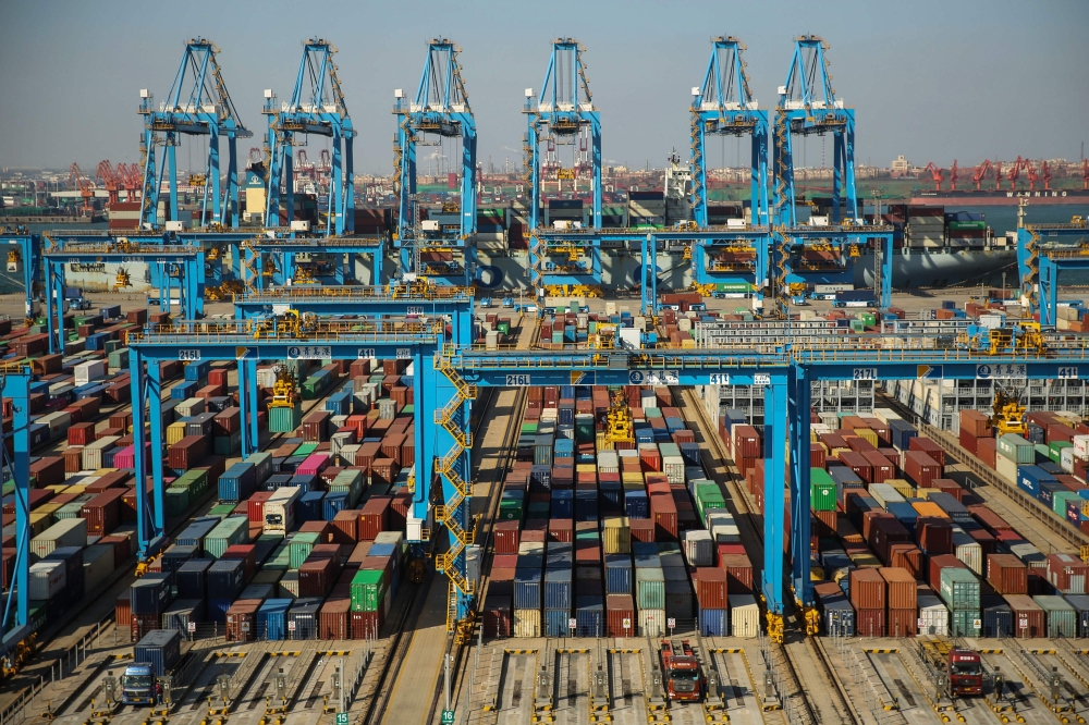 This file photo taken on November 28, 2019 shows containers stacked up at an automatic dock in Qingdao in Shandong province in east China. AFP
 