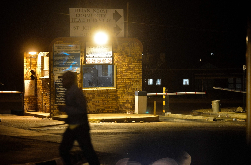 A pedestrian walks by the community centre at the Chris Hani Baragwanath Hospital in the South African landmark township of Soweto on April 24, 2014. AFP / Mujahid Safodien
