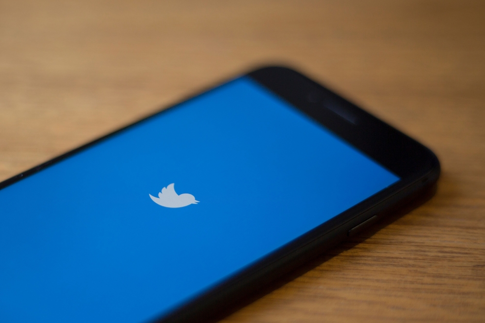 (FILES) In this file photo taken on July 10, 2019 The Twitter logo is seen on a phone in this photo illustration. AFP / Alastair Pike