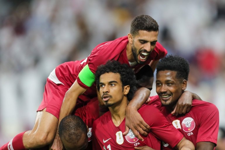Qatar players celebrate after scoring during a 24th Arabian Gulf Cup match. (AFP / KARIM JAAFAR/File Photo)