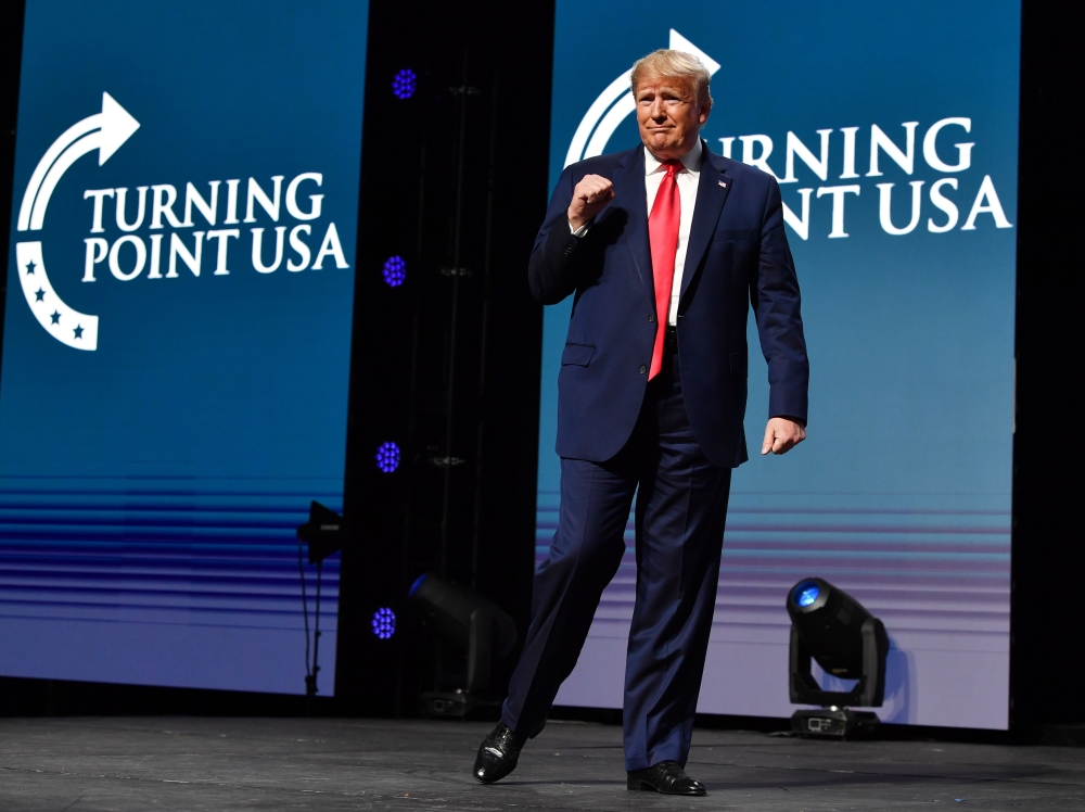 US President Donald Trump gestures during the Turning Point USA Student Action Summit at the Palm Beach County Convention Center in West Palm Beach, Florida on December 21, 2019. AFP / Nicholas Kamm 