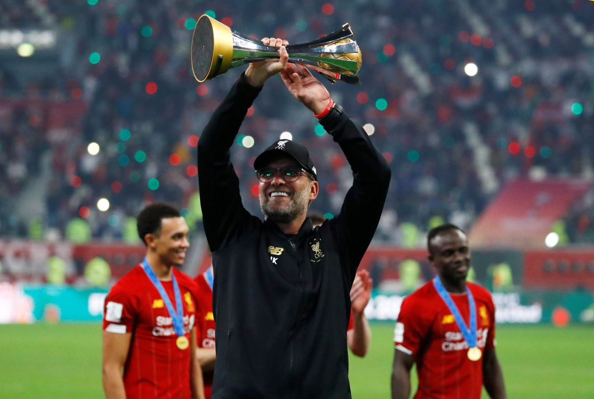 Liverpool’s manager Jurgen Klopp celebrates with the trophy. 