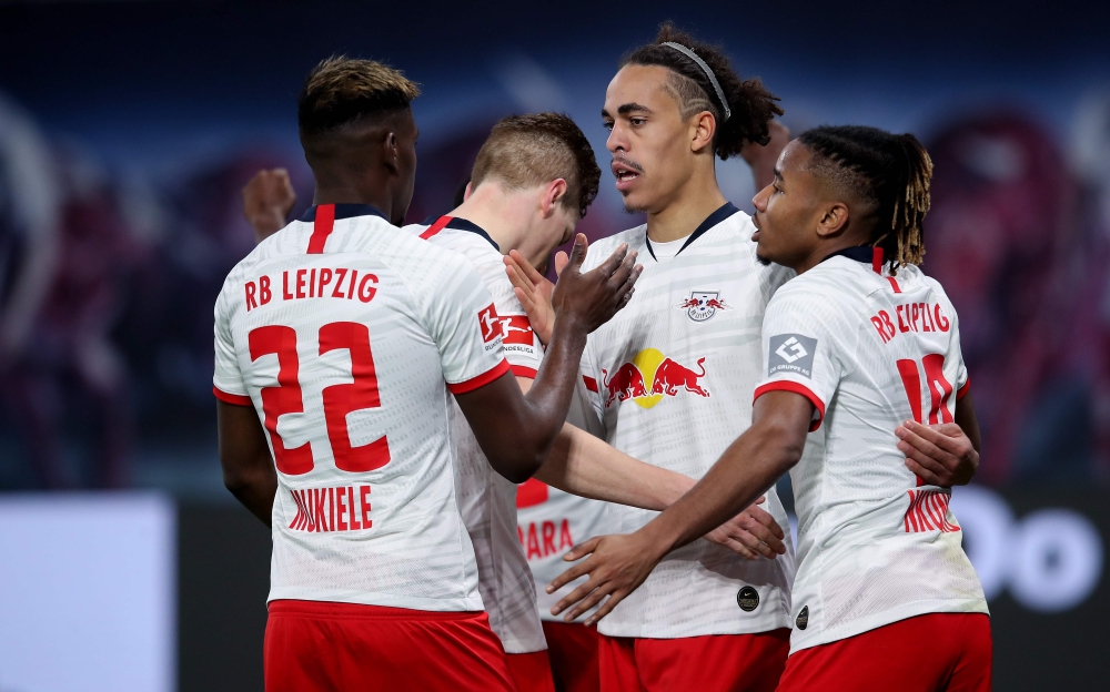 Leipzig's Danish forward Yussuf Poulsen (2nd R) celebrates after scoring the 3-1 lead with Leipzig's French defender Nordi Mukiele (L), Leipzig's German defender Marcel Halstenberg (2nd L) and Leipzig's French midfielder Christopher Nkunku (R) during the 