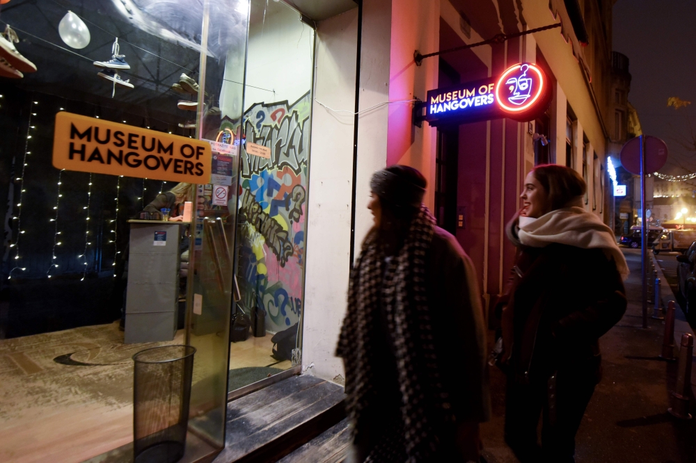 Two women walk past the Museum of Hangovers in Zagreb, on December 3, 2019. AFP / Denis Lovrovic
 