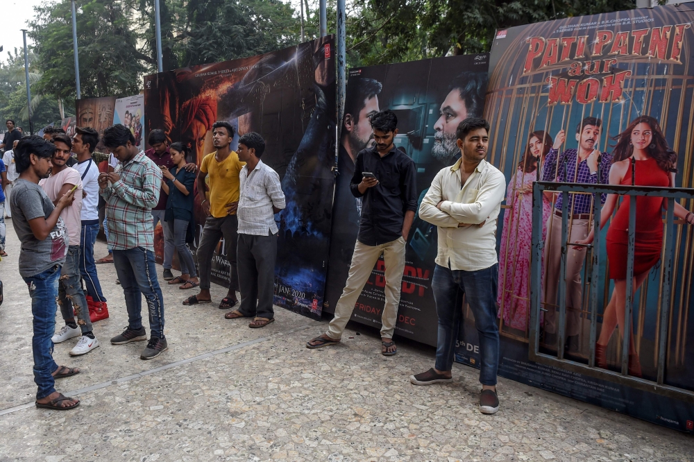In this photograph taken on December 1, 2019, people wait to enter a cinema in Mumbai.  AFP / Indranil Mukherjee