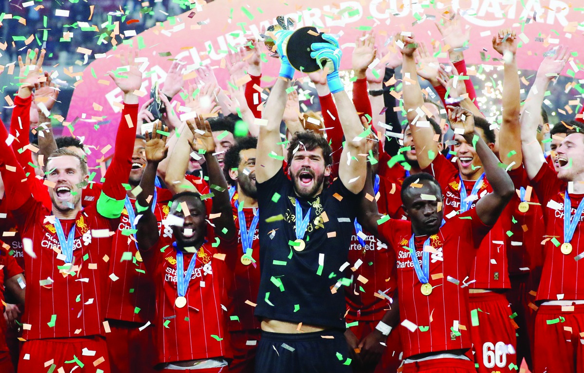 Liverpool's Alisson lifts the trophy as they celebrate after winning the Club World Cup in Doha. 