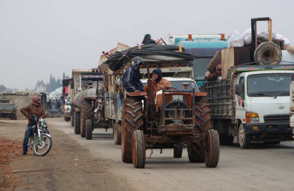 Trucks carry belongings of people fleeing from Maarat al-Numan, in northern Idlib, Syria December 24, 2019. Reuters/Mahmoud Hassano