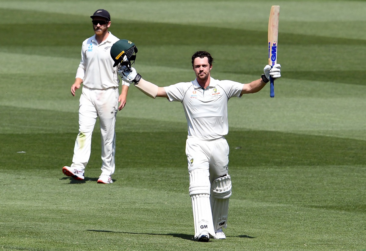 Australian batsman Travis Head celebrates scoring his century as New Zealand captain Kane Williamson (L) looks on during the second day of the second cricket Test match at the MCG in Melbourne on December 27, 2019. AFP / William West