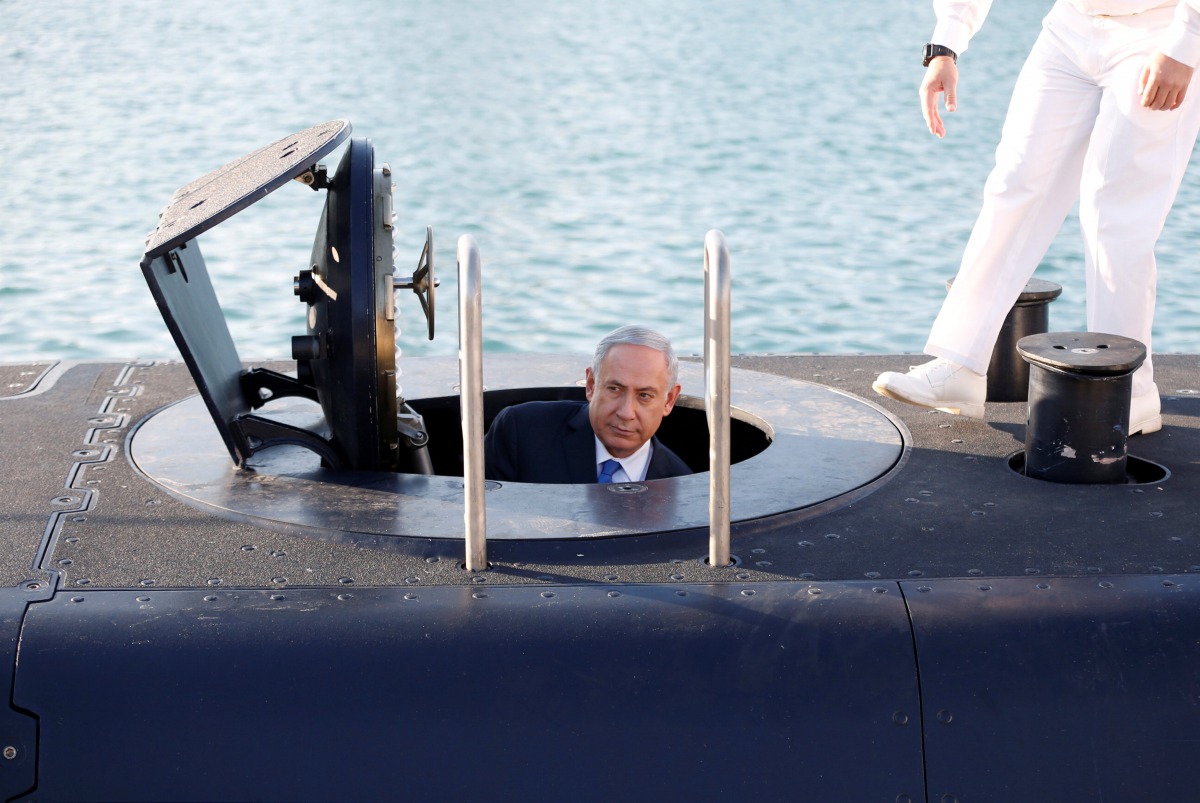 Israeli Prime Minister Benjamin Netanyahu climbs out after a visit inside the Rahav the fifth submarine in the fleet after it arrived in the Haifa port, January 12, 2016. Reuters / Baz Ratner