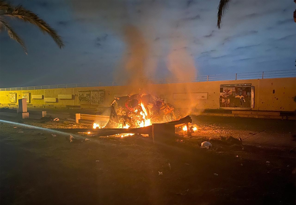 A picture published by the media office of the Iraqi military's joint operations forces on their official Facebook page shows a destroyed vehicle on fire following a US strike on January 3, 2020 on Baghdad international airport road in which top Iranian c