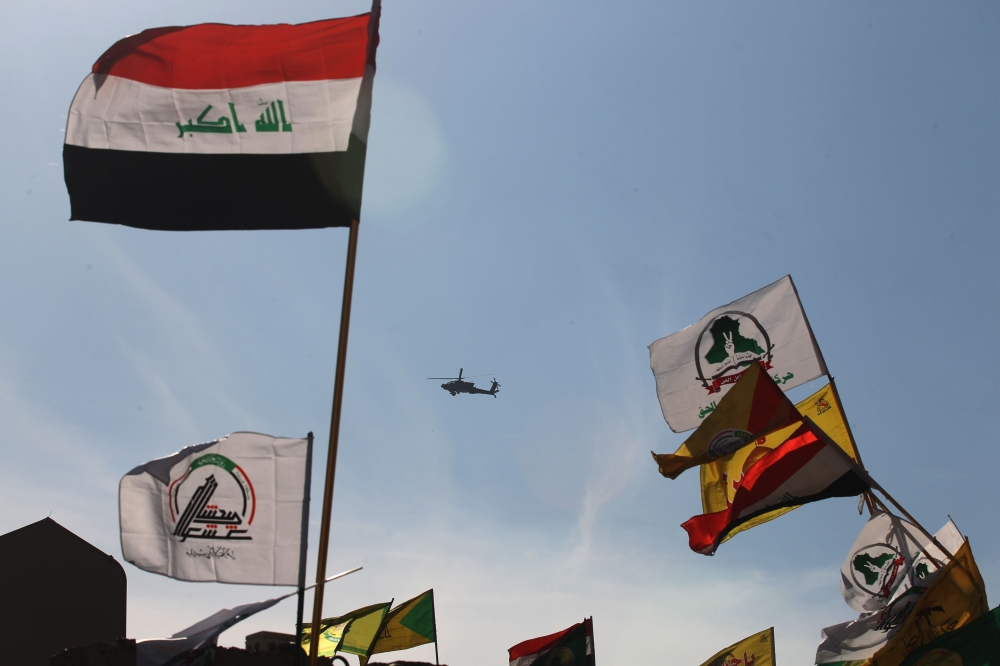 A military helicopter flies over the US embassy as supporters of Hashed al-Shaabi paramilitary protest in the Iraqi capital Baghdad on January 1, 2020. AFP / Ahmad Al-Rubaye