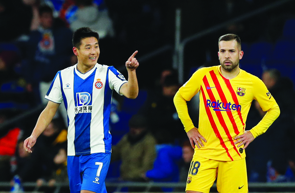 Espanyol's Wu Lei celebrates scoring their second goal as Barcelona's Jordi Alba looks dejected. (La Liga Santander, Espanyol v FC Barcelona, RCDE Stadium, Barcelona, Spain, January 4, 2020.)    Reuters/Albert Gea