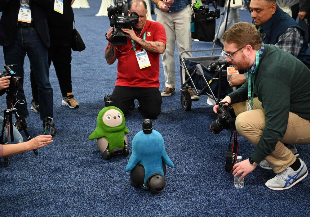 An attendee interacts with Lovot the companion robot by Grooxe X, during the CES Unveiled event at the 2020 Consumer Electronics Show (CES) in Las Vegas, Nevada, on January 5, 2020. AFP / Robyn Beck 