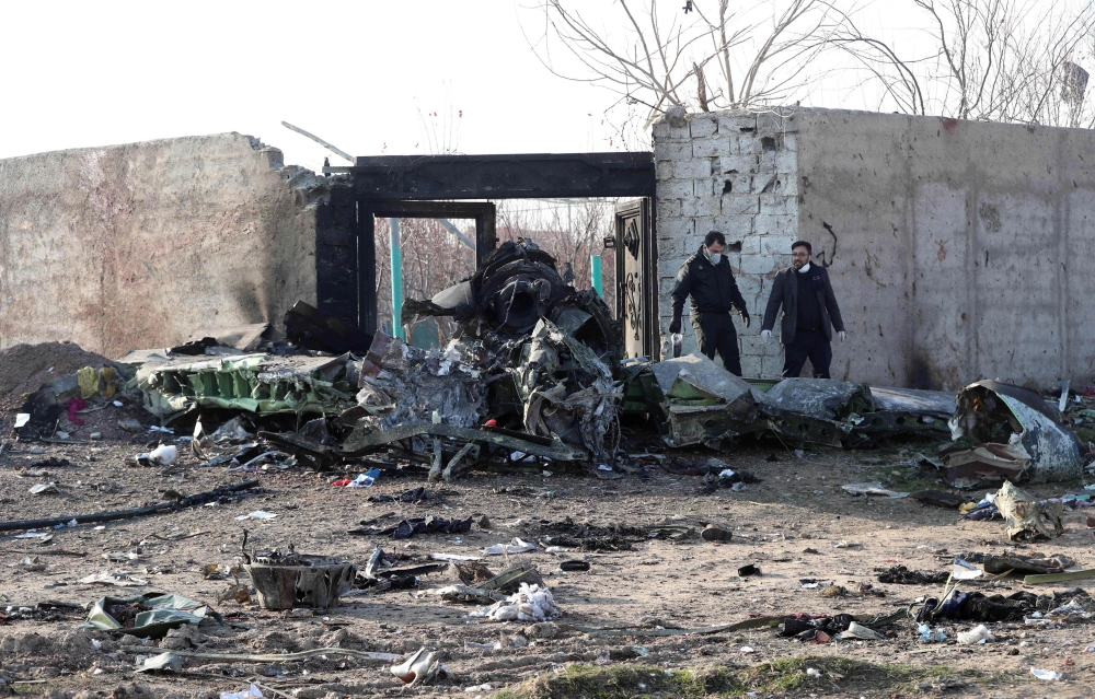 Rescue teams work amidst debris after a Ukrainian plane carrying 176 passengers crashed near Imam Khomeini airport in the Iranian capital Tehran early in the morning on January 8, 2020, killing everyone on board. AFP 