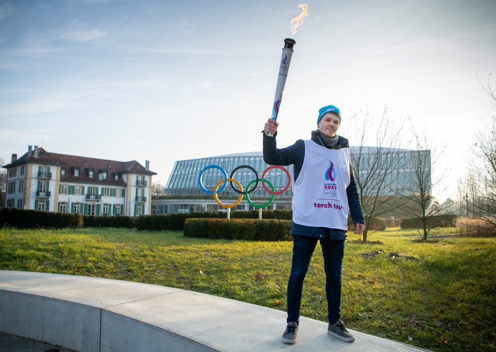  Olympics - 2020 Winter Youth Olympics - Lausanne, Switzerland - January 8, 2020 Nathanael Pianta poses with the Lausanne 2020 Youth Olympic Flame alongside the Olympic Rings outside Olympic House during the the final Torch Relay Joel Marklund for OIS/IOC