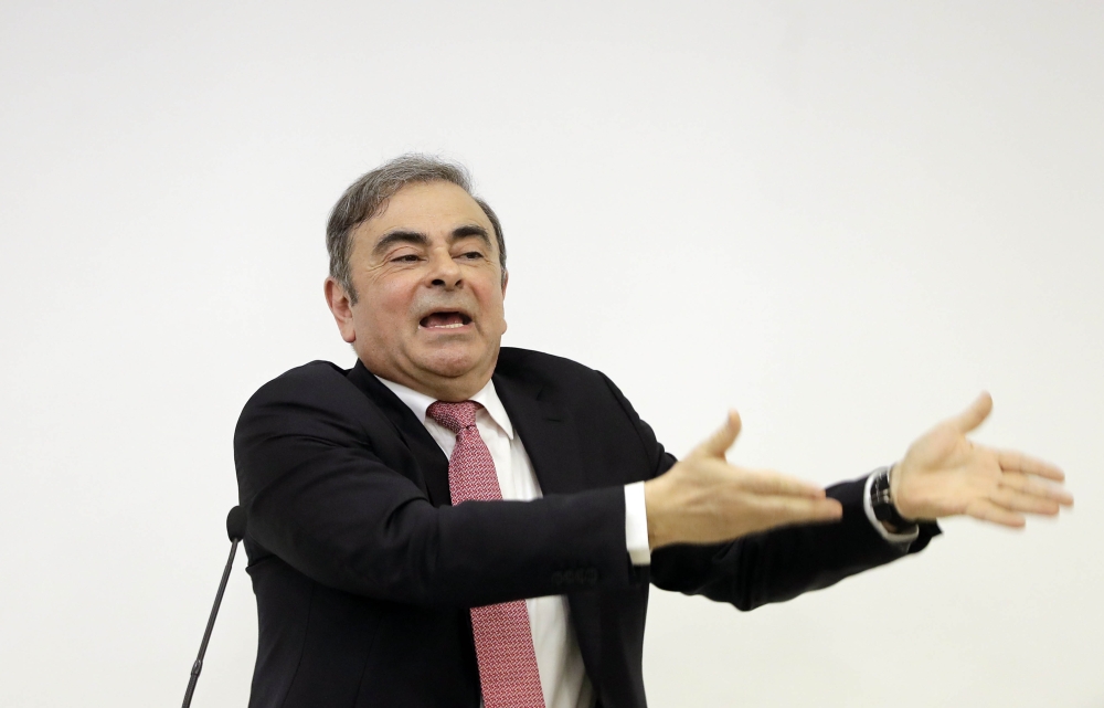 Former Renault-Nissan boss Carlos Ghosn gestures as he addresses a large crowd of journalists on his reasons for dodging trial in Japan, where he is accused of financial misconduct, at the Lebanese Press Syndicate in Beirut on January 8, 2020.   AFP / JOS